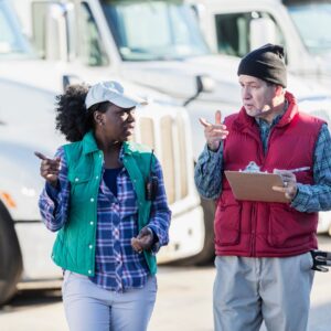 a man and women looking at a fleet of trucks for lease