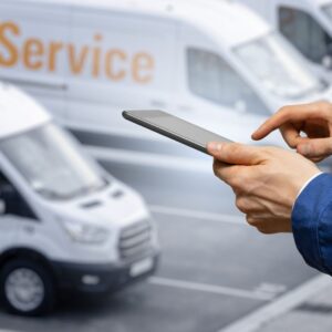 a man holding tablet inputting information of fleet vehicles
