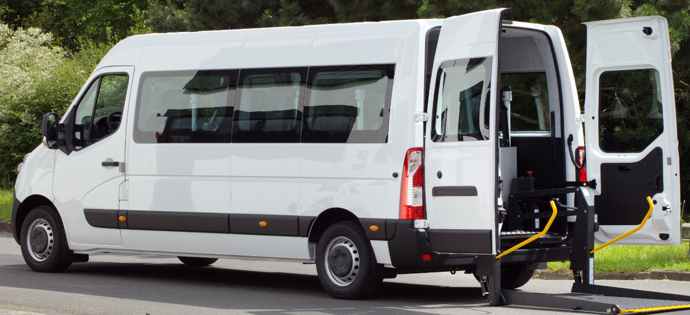 A mobility van with the rear doors open equipped with a wheelchair lift upfit