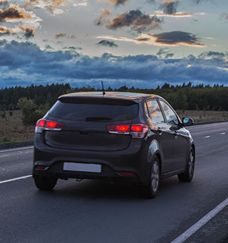A hatchback for Pharmaceutical delivery traveling down an open road