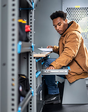 Man inside of upfitted van with shelving and racks installed