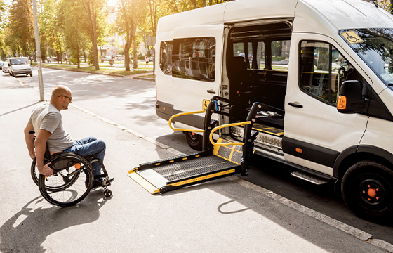 Man in a wheelchair approaching a life on an upfitted sprinter van