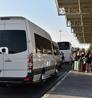 A sprinter van at the airport waiting to transport passengers