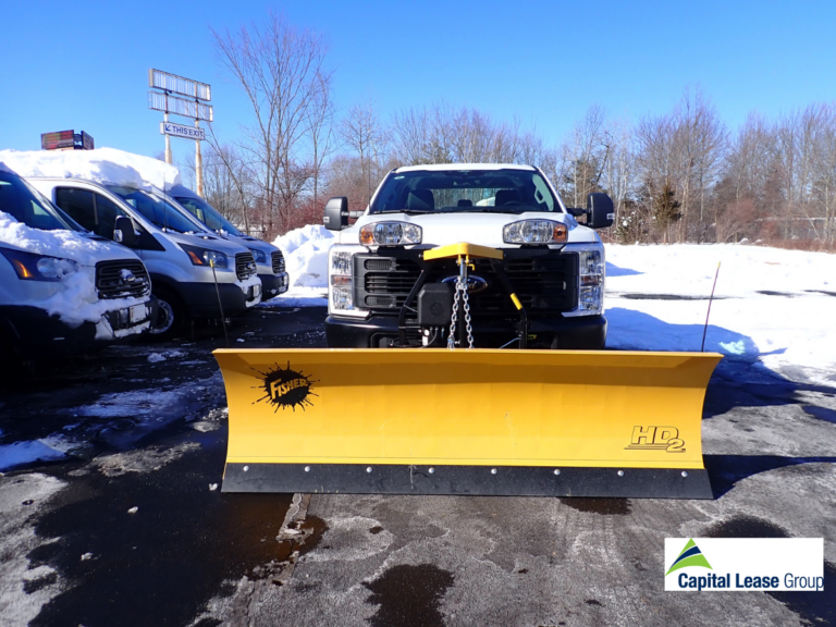 Fisher HD2 straight-blade snow plow mounted on a Ford F-250, showing the steel blade and Fisher yellow powder coat finish, ready for delivery to a Capital Lease Group customer