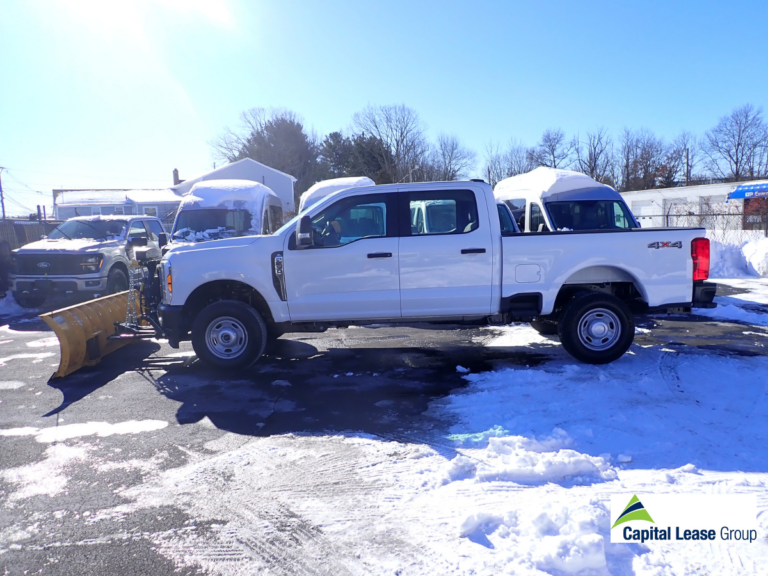 Side view of a Ford F-250 pickup equipped with a Fisher HD2 snow plow, ready for delivery to a Capital Lease Group customer