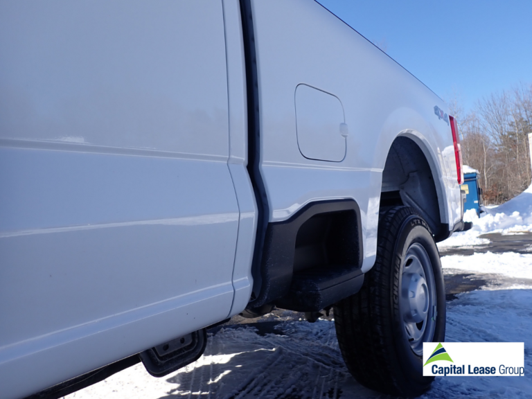 Ford F-250 cab and Fisher HD2 plow setup, showing the sidestep that gives access to the cab and the truck bed